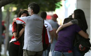 Fans of Argentina's River Plate team react after their team lost 2-1 the Copa Libertadores football final against Brazil's Flamengo at a bar in Buenos Aires, on November 23, 2019. 