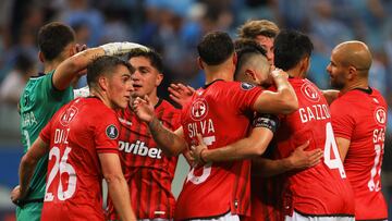 Players of Huachipato react after defeating Gremio during the Copa Libertadores group stage first leg football match between Brazil's Gremio