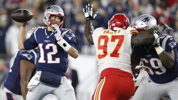 Oct 14, 2018; Foxborough, MA, USA; New England Patriots quarterback Tom Brady (12) makes a pass while pressured by Kansas City Chiefs defensive end Allen Bailey (97) during the first quarter at Gillette Stadium. Mandatory Credit: Greg M. Cooper-USA TODAY Sports