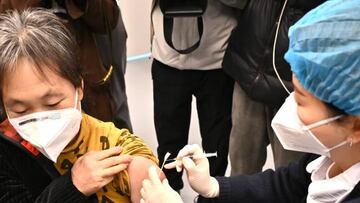 CHENGDU, CHINA - JANUARY 13: A medical worker vaccinates a citizen with Recombinant COVID-19 Vaccine (Sf9 Cell) at a community health service center on January 13, 2023 in Chengdu, Sichuan Province of China. (Photo by Tao Ke/Red Star News/VCG via Getty Images)