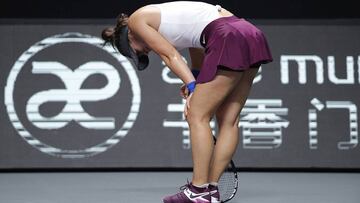 Bianca Andreescu of Canada suffers a knee injury during the WTA Finals Tennis Tournament against Karolina Pliskova of the Czech Republic in Shenzhen, China's Guangdong province, Wednesday, Oct. 30, 2019. (AP Photo/Andy Wong)