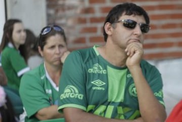 Fans of Brazil's soccer team Chapecoense gather outside the Arena Conda stadium in Chapeco, Brazil, Tuesday, Nov. 29, 2016. A chartered plane that was carrying the Brazilian soccer team to the biggest match of its history crashed into a Colombian hillside and broke into pieces, killing 75 people and leaving six survivors, Colombian officials said Tuesday. (AP Photo/Andre Penner)