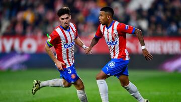 Girona's Brazilian midfielder #16 Savio Moreira (R) runs with the ball past Girona's Spanish defender #03 Miguel Gutierrez during the Spanish league football match between Girona FC and Real Sociedad at the Montilivi stadium in Girona on February 3, 2024. (Photo by PAU BARRENA / AFP)