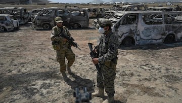 Members of the Taliban Badri 313 military unit stand besides damaged vehicles kept near the destroyed Central Intelligence Agency (CIA) base in Deh Sabz district northeast of Kabul on September 6, 2021.