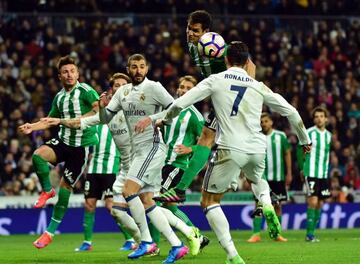 Real Madrid's Portuguese forward Cristiano Ronaldo (R) vies with Betis' Serbian midfielder Aissa Mandi (2R) and Real Madrid's French forward Karim Benzema (2L) during the Spanish league footbal match Real Madrid CF vs Real Betis at the Santiago Bernabeu