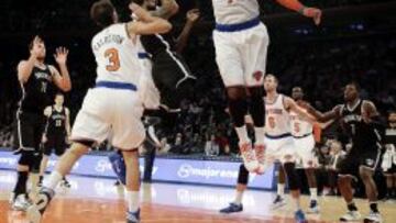 Deron Williams (c) de los Nets intenta un lanzamiento ante José Calderón (i) y Carmelo Anthony (d) de los Knicks.