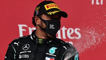 Winner Mercedes' British driver Lewis Hamilton celebrates with champagne on the podium after the Formula One Emilia Romagna Grand Prix at the Autodromo Internazionale Enzo e Dino Ferrari race track in Imola, Italy, on November 1, 2020. (Photo by MIGU
