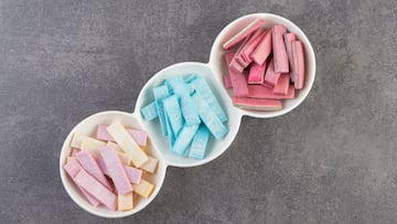 Colorful chewing gums placed on a stone background . High quality photo