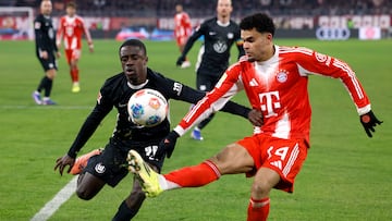 Soccer Football - Bundesliga - Bayern Munich v VfL Wolfsburg - Allianz Arena, Munich, Germany - January 11, 2026 Bayern Munich's Luis Diaz in action with VfL Wolfsburg's Sael Kumbedi REUTERS/Michaela Stache DFL REGULATIONS PROHIBIT ANY USE OF PHOTOGRAPHS AS IMAGE SEQUENCES AND/OR QUASI-VIDEO.