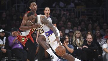 Nov 17, 2019; Los Angeles, CA, USA; Los Angeles Lakers forward LeBron James (23) moves the ball while Atlanta Hawks forward De'Andre Hunter (12) defends during the second quarter at Staples Center. Mandatory Credit: Kelvin Kuo-USA TODAY Sports
