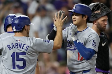 DENVER, COLORADO - SEPTEMBER 27: Shohei Ohtani #17 of the Los Angels Dodgers is congratulated by Austin Barnes #15 after hitting a three RBI home run against the Colorado Rockies in the sixth inning at Coors Field on September 27, 2024 in Denver, Colorado.   Matthew Stockman/Getty Images/AFP (Photo by MATTHEW STOCKMAN / GETTY IMAGES NORTH AMERICA / Getty Images via AFP)