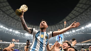 LUSAIL CITY, QATAR - DECEMBER 18: Lionel Messi of Argentina celebrates with the FIFA World Cup Qatar 2022 Winner's Trophy after the team's victory during the FIFA World Cup Qatar 2022 Final match between Argentina and France at Lusail Stadium on December 18, 2022 in Lusail City, Qatar. (Photo by Shaun Botterill - FIFA/FIFA via Getty Images)