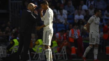 Real Madrid&#039;s French coach Zinedine Zidane talks to Real Madrid&#039;s French defender Raphael Varane during the Spanish league football match between Real Madrid CF and RC Celta de Vigo at the Santiago Bernabeu stadium in Madrid on March 16, 2019. (