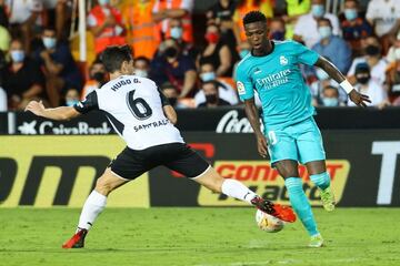 Valencia's Spanish defender Hugo Guillamon (L) vies with Real Madrid's Brazilian forward Vinicius Junior.