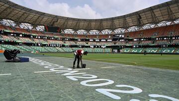 Ground staff paint the pitch ahead of the Africa Cup of Nations (CAN) 2024 group A football match between Nigeria and Equatorial Guinea at the Alassane Ouattara Stadium in Ebimpe, Abidjan, on January 14, 2024. (Photo by Issouf SANOGO / AFP)