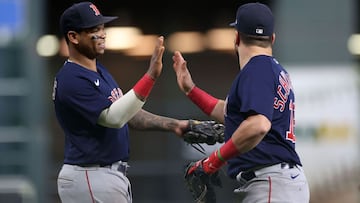 HOUSTON, TEXAS - OCTOBER 16: Rafael Devers #11 congratulates Kyle Schwarber #18 of the Boston Red Sox after the final out of the seventh inning of their game against the Houston Astros in the Game Two of the American League Championship Series at Minute M