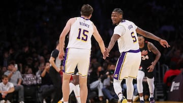 LOS ANGELES, CALIFORNIA - NOVEMBER 12: Austin Reaves #15 and Cam Reddish #5 of the Los Angeles Lakers slap hands during the first half against the Portland Trail Blazers at Crypto.com Arena on November 12, 2023 in Los Angeles, California. NOTE TO USER: User expressly acknowledges and agrees that, by downloading and or using this photograph, User is consenting to the terms and conditions of the Getty Images License Agreement. Meg Oliphant/Getty Images/AFP (Photo by Meg Oliphant / GETTY IMAGES NORTH AMERICA / Getty Images via AFP)