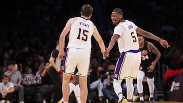 LOS ANGELES, CALIFORNIA - NOVEMBER 12: Austin Reaves #15 and Cam Reddish #5 of the Los Angeles Lakers slap hands during the first half against the Portland Trail Blazers at Crypto.com Arena on November 12, 2023 in Los Angeles, California. NOTE TO USER: User expressly acknowledges and agrees that, by downloading and or using this photograph, User is consenting to the terms and conditions of the Getty Images License Agreement.   Meg Oliphant/Getty Images/AFP (Photo by Meg Oliphant / GETTY IMAGES NORTH AMERICA / Getty Images via AFP)