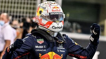Red Bull's Dutch driver Max Verstappen celebrates in the Parc Ferme of the Yas Marina Circuit after he took the pole position during the qualifying session of the Abu Dhabi Formula One Grand Prix on December 11, 2021. (Photo by ANDREJ ISAKOVIC / AFP)