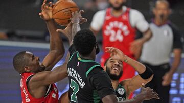Toronto Raptors' Serge Ibaka, left, battles for the ball with Boston Celtics' Jaylen Brown (7) and Boston Celtics' Jayson Tatum, right, during the first half of an NBA conference semifinal playoff basketball game Monday, Sept. 7, 2020, in L