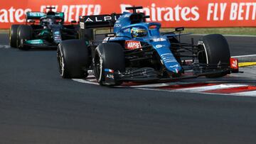 Alonso se protege de Hamilton durante la carrera en Hungría.