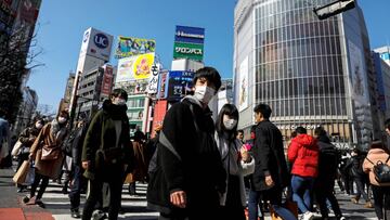 Personas con mascarilla por temor al contagio del coronavirus cruzan en el famoso paso de peatones de Shibuya en Tokio, Jap&oacute;n.