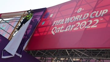 A worker fixes banners at Souq Waqif, which has been decorated ahead of the FIFA World Cup 2022 soccer tournament in Doha, Qatar November 11, 2022. REUTERS/Amr Abdallah Dalsh