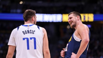 DENVER, COLORADO - NOVEMBER 10: Luka Doncic #77 of the Dallas Mavericks and Nikola Jokic #15 of the Denver Nuggets chat during a free throw in the first half at Ball Arena on November 10, 2024 in Denver, Colorado. NOTE TO USER: User expressly acknowledges and agrees that, by downloading and or using this photograph, user is consenting to the terms and conditions of the Getty Images License Agreement. Tyler Schank/Clarkson Creative/Getty Images/AFP (Photo by Tyler Schank/Clarkson Creative / GETTY IMAGES NORTH AMERICA / Getty Images via AFP)