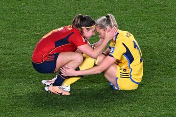 (FILES) Sweden's forward #18 Fridolina Rolfo (R) is consoled by Spain's forward #08 Mariona Caldentey at the end of the Australia and New Zealand 2023 Women's World Cup semi-final football match between Spain and Sweden at Eden Park in Auckland on August 15, 2023. No matter what happens in the August 20 final between England and Spain, opposing players consoling each other after games will go down as some of the enduring images of the Women's World Cup. (Photo by Saeed KHAN / AFP) / To go with AFP story FBL-WC-women-consolation by Peter Stebbings