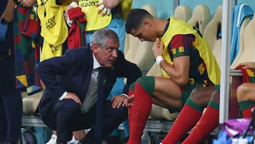 06 December 2022, Qatar, Lusail: Soccer, Qatar 2022 World Cup, Portugal - Switzerland, Round of 16, at Lusail Stadium, Portugal coach Fernando Santos talks to Portugal's Cristiano Ronaldo, who is about to be substituted. Photo: Tom Weller/dpa (Photo by Tom Weller/picture alliance via Getty Images)