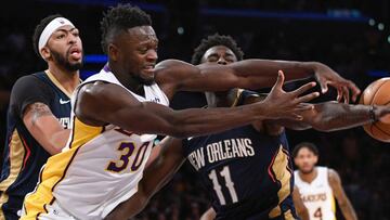 Oct 22, 2017; Los Angeles, CA, USA; Los Angeles Lakers forward Julius Randle (30) battles New Orleans Pelicans guard Jrue Holiday (11) for a loose ball during the fourth quarter at Staples Center. Left is New Orleans Pelicans forward Anthony Davis (23). The Pelican hung on for a 119-112 win. Mandatory Credit: Robert Hanashiro-USA TODAY Sports