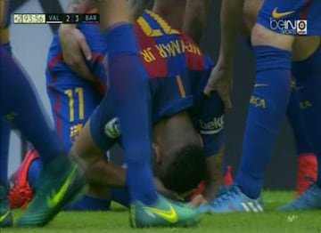 Neymar clutches his head after being struck by missile