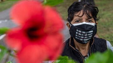 Norma Rivera Arriola (56), mother of Shirley Villanueva Rivera (24), who disappeared 4 years ago, poses for a picture while holding a portrait of her daughter in Lima, on July 14, 2021. - Five cases a day before the COVID-19 pandemic, eight during the 2020 quarantine and 16 now: the disappearances of women register a silent but "alarming" increase in Peru, which is experiencing an endless electoral process. (Photo by ERNESTO BENAVIDES / AFP)