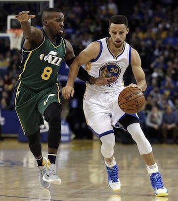 Golden State Warriors' Stephen Curry drives the ball against Utah Jazz's Shelvin Mack (8) during the first half.