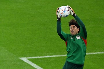 Mexico's goalkeeper #13 Guillermo Ochoa warms up ahead of the Qatar 2022 World Cup Group C football match between Saudi Arabia and Mexico at the Lusail Stadium in Lusail, north of Doha on November 30, 2022. (Photo by Pablo PORCIUNCULA / AFP)