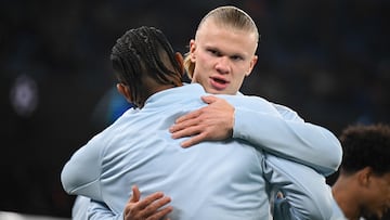 Manchester City's Swiss defender #25 Manuel Akanji (L) and Manchester City's Norwegian striker #09 Erling Haaland (R) embrace as they warm up ahead of the UEFA Champions League round of 16, second-leg, football match between Manchester City and FC Copenhagen at the Etihad Stadium, in Manchester, north west England, on March 6, 2024. (Photo by Oli SCARFF / AFP)
