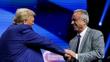 FILE PHOTO: Robert F. Kennedy Jr. and Republican presidential candidate and former U.S. President Donald Trump greet each other at a campaign event sponsored by conservative group Turning Point USA, in Duluth, Georgia, U.S., October 23, 2024. REUTERS/Carlos Barria/File Photo