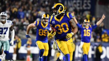Jan 12, 2019; Los Angeles, CA, USA; Los Angeles Rams running back Todd Gurley (30) runs in a touchdown in the second quarter against the Dallas Cowboys in a NFC Divisional playoff football game at Los Angeles Memorial Stadium. Mandatory Credit: Robert Han