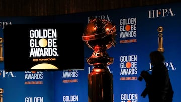 FILE PHOTO: A person holds a camera next to the Golden Globe statue before the 79th Annual Golden Globe Awards nominations announcement in Beverly Hills, California, U.S., December 13, 2021. REUTERS/Mario Anzuoni/File Photo