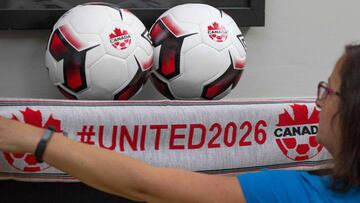 An employee holds up a scarf with the hashtag for World Cup in 2026 at Soccer Canada Headquarters in Ottawa, Ontario on June 13, 2018, as Canada will co-host the 2026 World Cup with Mexico and the US.
The 2026 World Cup hosted by Canada, Mexico and the United States will be "a great tournament," Canadian Prime Minister Justin Trudeau said Wednesday, setting aside a simmering trade dispute with Washington. "Good news this morning: The 2026 FIFA World Cup is coming to Canada, the US and Mexico," the prime minister said in a Twitter message. "Congratulations to everyone who worked hard on this bid x96- it's going to be a great tournament!"
/ AFP PHOTO / Lars Hagberg