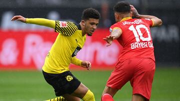 DORTMUND, GERMANY - MAY 22: Jadon Sancho of Borussia Dortmund is put under pressure by Kerem Demirbay of Bayer Leverkusen during the Bundesliga match between Borussia Dortmund and Bayer 04 Leverkusen at Signal Iduna Park on May 22, 2021 in Dortmund, Ger