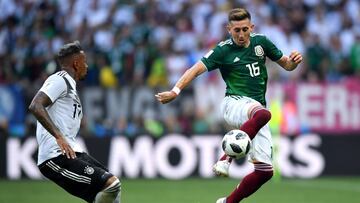 MOSCOW, RUSSIA - JUNE 17:  Hector Herrera of Mexico controls the ball as Jerome Boateng of Germany looks on during the 2018 FIFA World Cup Russia group F match between Germany and Mexico at Luzhniki Stadium on June 17, 2018 in Moscow, Russia.  (Photo by H