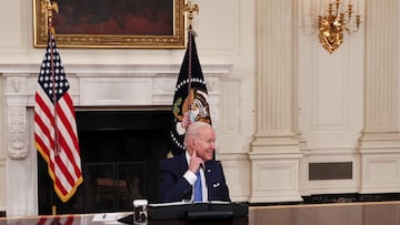 President Joe Biden listens to reporters shout questions while hosting a roundtable with CEOs of utilities to discuss the 'Build Back Better' agenda, in the State Dining Room at the White House.