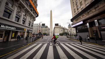 BUENOS AIRES, ARGENTINA - JULY 02: A delivery worker crosses Corrientes avenue on July 2, 2020 in Buenos Aires, Argentina. According to the national statistics bureau (INDEC), economy in Argentina shrank 26% year on year in April, the first full month of coronavirus lockdown. Due to increasing number of cases in Buenos Aires Aires and its metropolitan area, authorities tightened restrictions allowing only essential shops and industries to remain open to public. Apart from dealing with the pandemic, Argentina is on default and holds a negotiation with creditors to restructure a 66 billion USD debt. (Photo by Marcelo Endelli/Getty Images) ***BESTPIX***