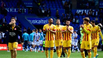 Girona's players applaud at the end of the Spanish league football match between Real Sociedad and Girona FC at the Reale Arena stadium in San Sebastian on May 13, 2023. (Photo by ANDER GILLENEA / AFP)