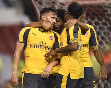 Lucas Perez celebrates scoring their third goal with team mates.