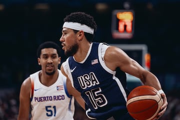 Devin Booker of USA (R) in action against Tremont Waters of Puerto Rico.