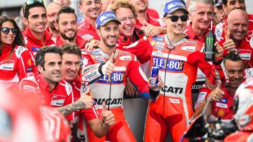 Ducati Team&#039;s riders Andrea Dovizioso of Italy (Center ) and Jorge Lorenzo of Spain (Center R) celebrate with their team after the qualifying session of the MotoGP Austrian Grand Prix weekend at Red Bull Ring in Spielberg, Austria on August 12, 2017.