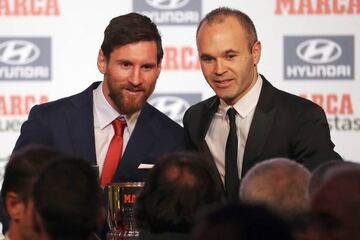 FC Barcelona's Leo Messi and Andrés Iniesta picking up their awards.