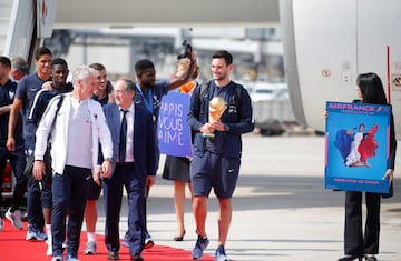 Soccer Football - World Cup - The France team return from the World Cup in Russia - Charles de Gaulle Airport, Paris, France - July 16, 2018   France's Hugo Lloris holds the trophy as he arrives   